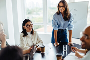 Poster - Woman discussing a new project with her team in a meeting