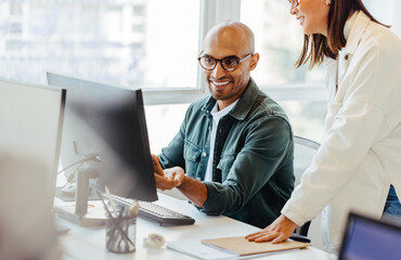 Poster - Software engineers using a computer and having a discussion in an office