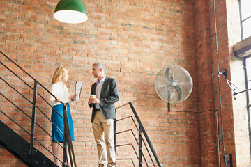 Aufkleber - Business people, planning and standing in office talking, having conversation and discussion. Teamwork, stairs and employees in workplace with paper, document and conversation in on startup project