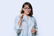 © Valerii Honcharuk - Middle aged serious woman showing index finger up, on white background