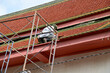 BANGKOK, THAILAND - November 20, 2022 : Thai workers are renovating the roof of the pavilion in Thai temple in Thailand with Blue Sky Background.