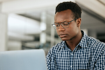 Poster - Thinking, black man and laptop for business, online reading and search internet in office. Young male, entrepreneur and computer for trading, concentration or focus for research, stress and workplace