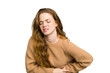 © Asier - Young caucasian redhead woman isolated having a liver pain, stomach ache.