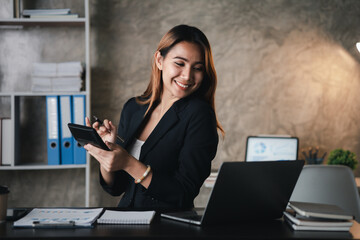 Wall Mural - Asian women working in the office, young Asian business women as business executives, founding and running start-up executives, young female business leaders. Startup business concept.