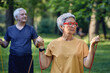 © Alex Tihonov - Senior couple doing exercises outdoor using resistance rubber bands