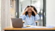 © David - Portrait of tired young business african american woman work with documents tax laptop computer in office. Sad, unhappy, Worried, Depression, or employee life stress concept
