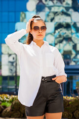 Canvas Print - Portrait of a young beautiful brunette woman in white shirt