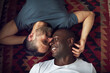 © Flamingo Images - Soft gay men lying on floor together