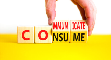 Consume or communicate symbol. Concept word Consume or Communicate on wooden cubes. Beautiful yellow table white background. Businessman hand. Business consume communicate concept. Copy space.