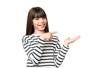 Wall Mural - Little caucasian girl over isolated background holding copyspace imaginary on the palm to insert an ad