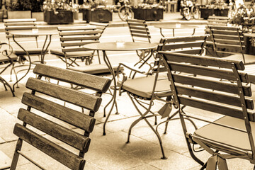 Sticker - table and chairs at a sidewalk cafe