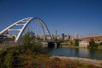 Wall Mural - Modern arc bridge over the river,  day traffic, summer time. modern architecture, panorama of the city Edmonton