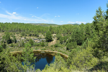 Wall Mural - Canada del Hoyo Lagoons Natural monument makes up a rugged area with hiking routes amid karst rock formations, pine forest & sinkholes, Cuenca, Spain