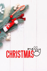 Wall Mural - Merry Christmas text with Xmas composition made from pine tree, snowflakes and festive decorations top view