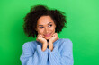 Leinwandbild Motiv Photo of careless dreamy girl curly hairstyle in blue pullover look empty space palms touch cheeks isolated on green color background
