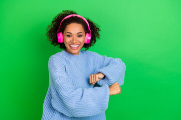 Sticker - Portrait of overjoyed positive girl dance hands make moves listen music isolated on green color background