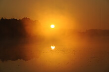The Sun Rises On A Lake In The Fall 