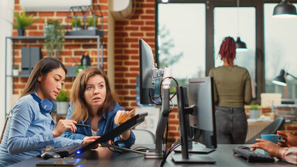 Professional team of developers working with 3d graphics software, brainstorming new ideas. Man and woman colleagues using artificial intelligence to create digital project at job.