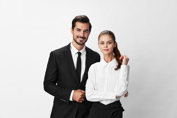 Wall Mural - Man and woman smile with teeth business in business attire looking into camera on white isolated background. Stylish business concept paired between employees startup copy space