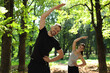 © New Africa - Man and woman doing morning exercise in park