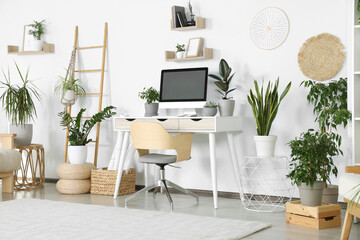 Sticker - Comfortable workplace with modern computer and different houseplants in room