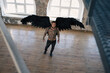 © Viktoria - handsome man with wings.Male angel with black wings.  Muscular shirtless man with whip. Brutal handsome man with tattooed body. Muscular athletic sexy male