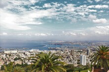 Aerial Shot Of The City Haifa, Israel Covered With White Buildings And Water