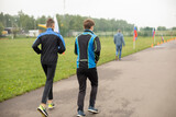 Fototapeta  - Jogging in park. Students run in stadium.