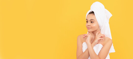 Canvas Print - Girl with healthy skin, facial treatment, smiling teen girl in shower towel with cream on face. Cosmetics and skin care for teenager child, poster design. Beauty kid girl banner with copy space.