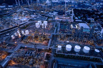 Wall Mural - aerial view oil refinery Oil and gas industry, petrochemical plant area and energy concept, oil storage tanks at night time with lights.