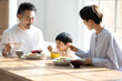 © kapinon - Asian family table with children who love rice