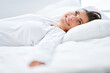 © Kalim - Nice female in bed relaxing or doing yoga