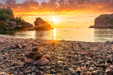 Wall Mural - morning or evening landscape with nice beach , a sunrise or sunset in sea with amazing isle with rocks and beautiful clouds on background