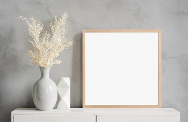 Blank picture frame mockup on gray wall. White living room design. View of modern scandinavian style interior with artwork mock up on wall. Home staging and minimalism concept