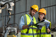 © kelvn - Portrait of female automation engineer team standing and working in industrial factory.