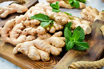 Fresh ginger root. Foods containing vitamin C. Free space for text on a stone background.