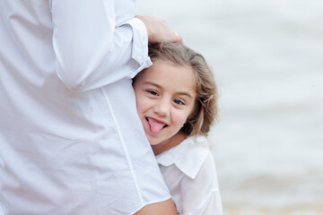 Happy little girl on the beach.  Sea holidays, travel and beach holidays with children