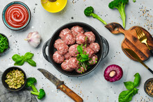 Fresh Raw Beef Meatballs With Spices In A Pan. Top View. On A Stone Background.