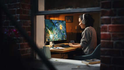 Cheerful Female Gamer Playing Online Video Game on Personal Computer. Professional Woman Player Enjoying Fantasy RPG. Real Role Playing Character Casting Magic Spells, Destroying Enemies. Window View.