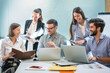 © Bojan - Group of smiling confidence business people working together at meeting table in the office.