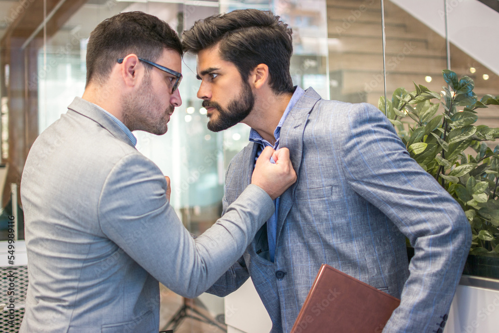 Business conflict between two business men in formal-wear in office ...