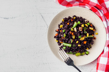 Wall Mural - delicious black rice with vegetables on a white background