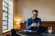 © bnenin - Smiling man chatting with someone over the mobile phone, being at the office.