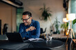 © bnenin - Smiling businessman working over the laptop, having an online meeting.