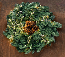Wall Mural - christmas wreath with golden lights on dark rustic table top view, copyspace. xmas garland, new year