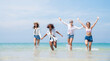 © kelvn - Happy friends at beach party runs together on the beach having fun in a sunny day, Beach summer holiday sea people concept