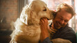 © Gorodenkoff - Happy Handsome Young Man Play with Dog at Home, Gorgeous Golden Retriever. Attractive Man Sitting on a Floor. Excited Dog Licking the Owner that Teases the Pet. Having Fun in the Stylish Apartment.
