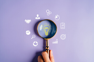 Fototapete - Magnifying glass focus to light bulb icon which for mind, creative, idea, innovation, motivation planning development leadership and customer target group concept.