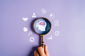 Wall Mural - Magnifying glass focus to human brain with light bulb icon which for mind, creative, idea, innovation, motivation planning development leadership and customer target group concept.