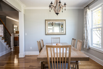 Wall Mural - An open coastal dining room in a new construction house with hard wood floors